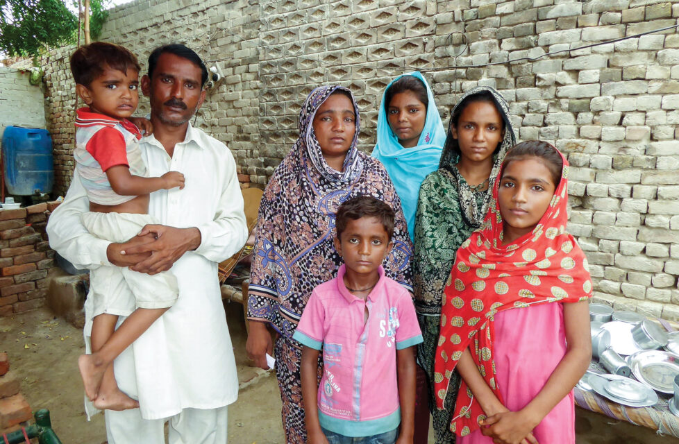 Central Asia Secret Worship Meetings in Cars Central Asian family stands in front of wall