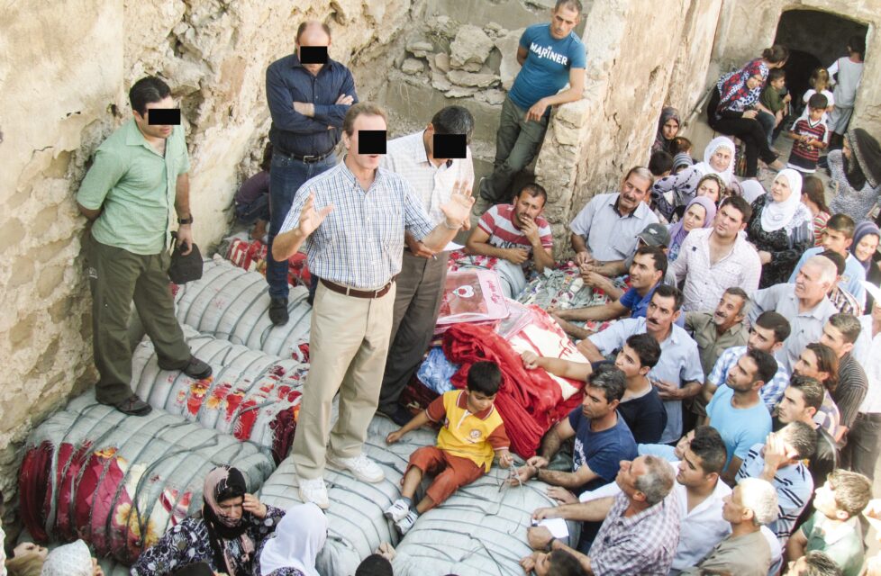 A man preaches to a large group of people outside